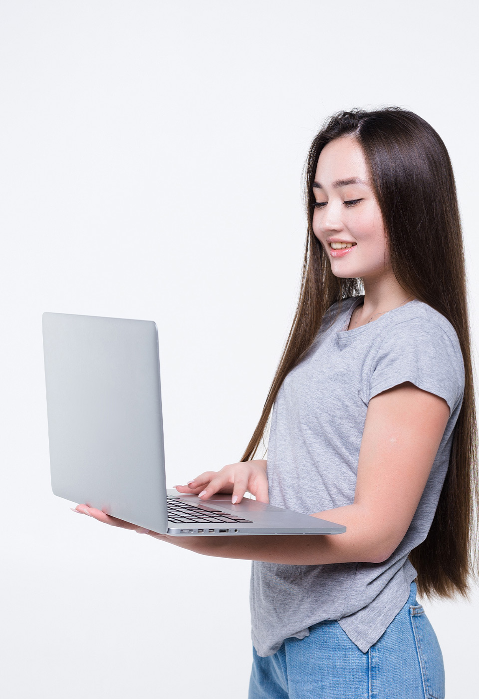 image of woman holding up her laptop and smiling at the website she got from Inception Designs